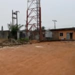 A full plot of land that is fenced and sand filled in a lovely location